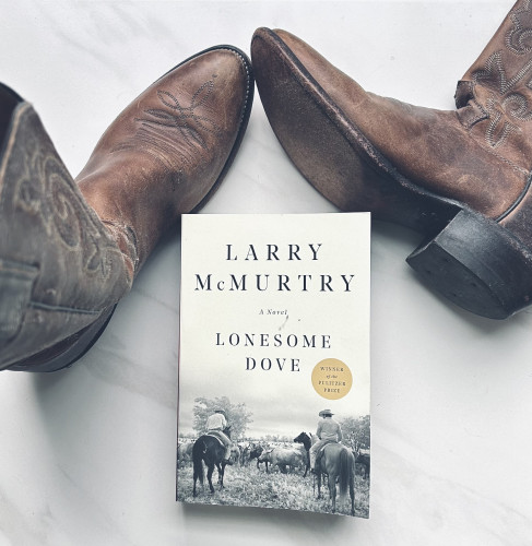 My cowboy boots that are over 20 years old and the book, Lonesome Dove by Larry McMurtry sits between them.