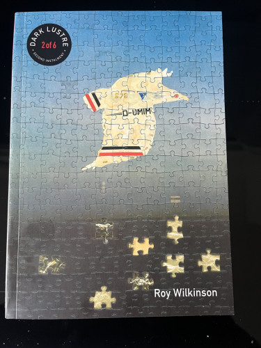 Cover of Dark Lustre, part 2 - Roy Wilkinson. A stylised bird flies over the sea. The cover image looks like it is made up of jigsaw pieces.