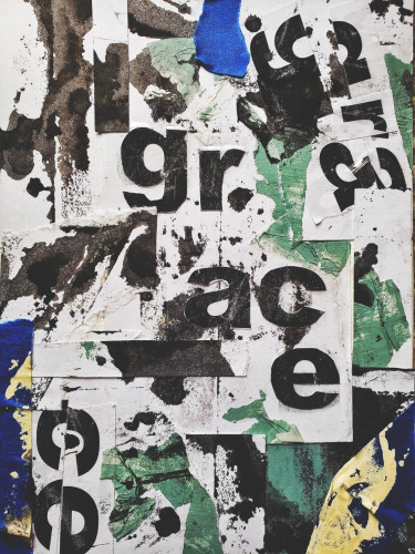A collage of torn inked paper and blue painter's tape with typography that says "grace"