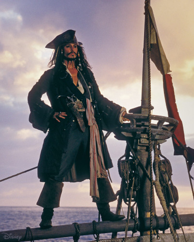 Jack Sparrow from Pirates of the Caribbean standing on top the sail holding on top the top of the mast.