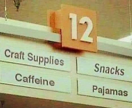 Aisle in a grocery store. The sign reads: craft supplies, snacks, caffeine, pajamas.