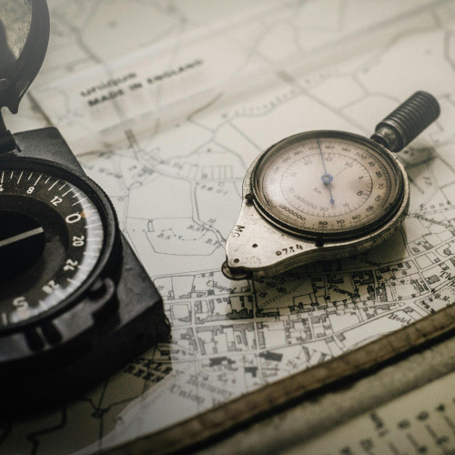 a compass sitting on top of a map