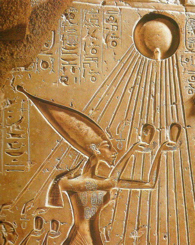 Pharaoh Akhenaten praying to the sun god Aten.