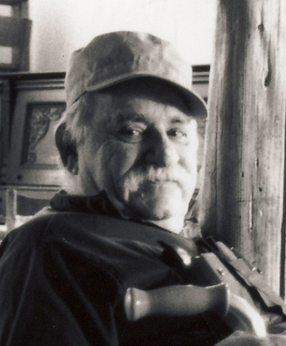 Portrait of Murray Bookchin, with gray moustache and cap, by Janet Biehl - Own work, Public Domain, https://commons.wikimedia.org/w/index.php?curid=110949541