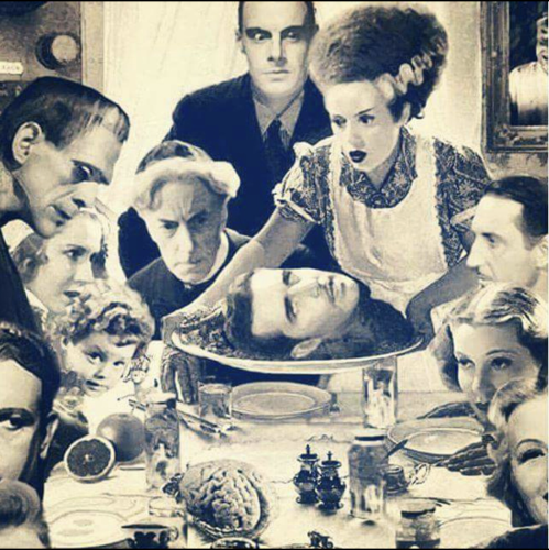 A table set up for a feast with the Bride of Frankenstein serving up a plate with a head on it while Frankenstein and people look on
