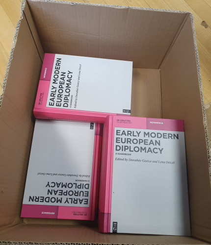 Box with several copies of the Early modern European Diplomacy Handbook. 