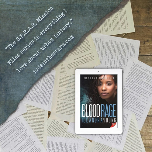 On a backdrop of book pages, an iPad with the cover of Blood Rage (The S.P.E.A.R. Mission Files #3) by Ileandra Young. In the top left corner of the image, a strip of torn paper with a quote: "The S.P.E.A.R. Mission Files series is everything I love about urban fantasy." and a URL: judeinthestars.com.