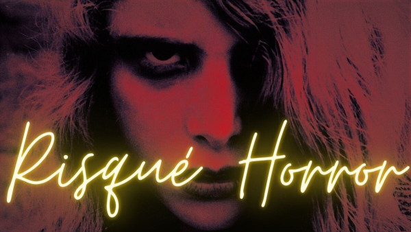 "Risqué Horror" in yellow cursive style writing on a red-tinted background photo of a close-up of a young woman staring at the viewer. Dark rings are around her eyes and part of her face is covered by blond hair.